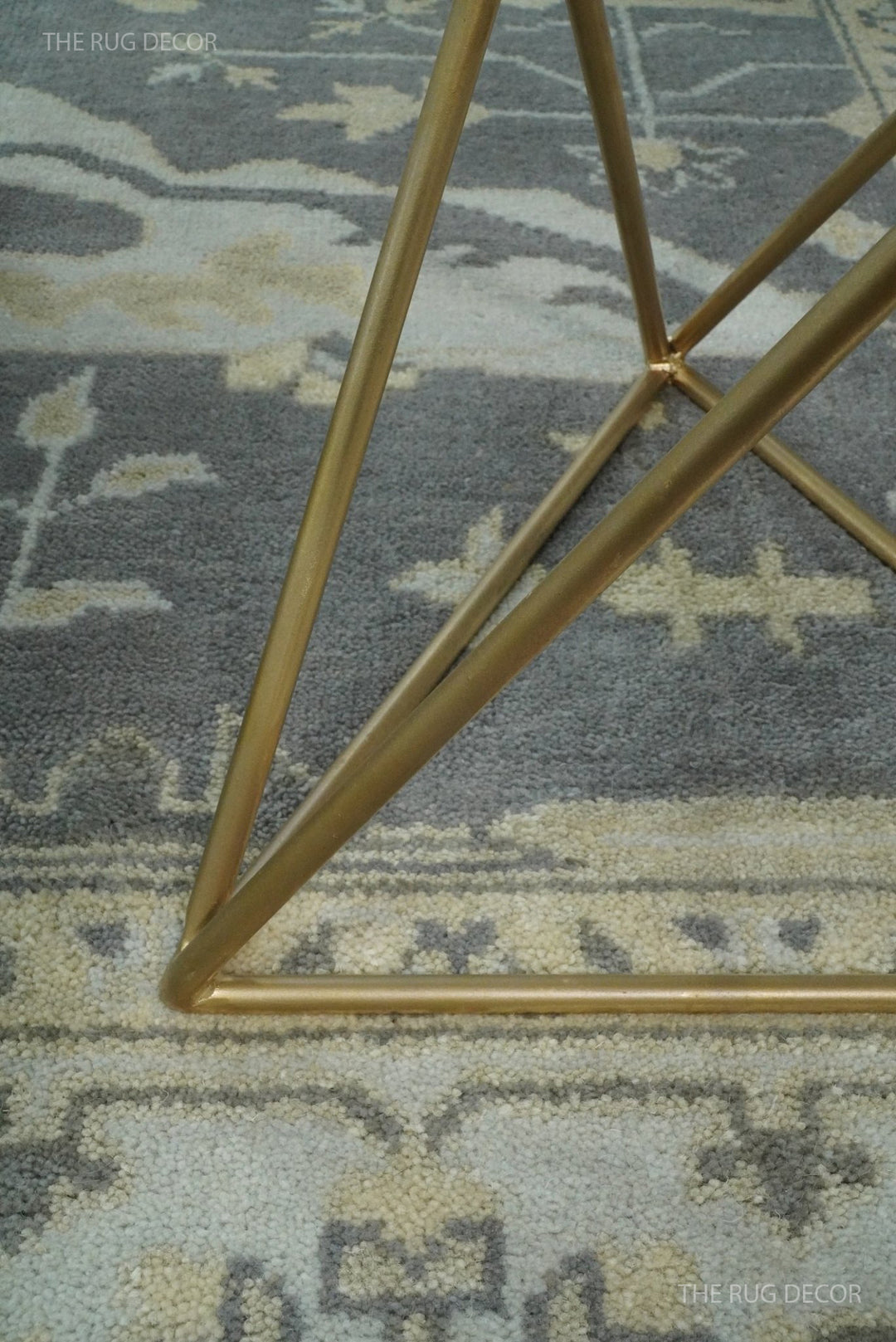 Close-up of vintage Oushak-style rug texture in gray with ivory pattern highlights