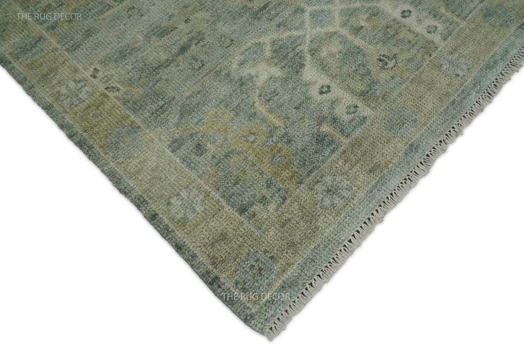 Rug corner showing the blue and ivory pattern, bound edge, and fringe
