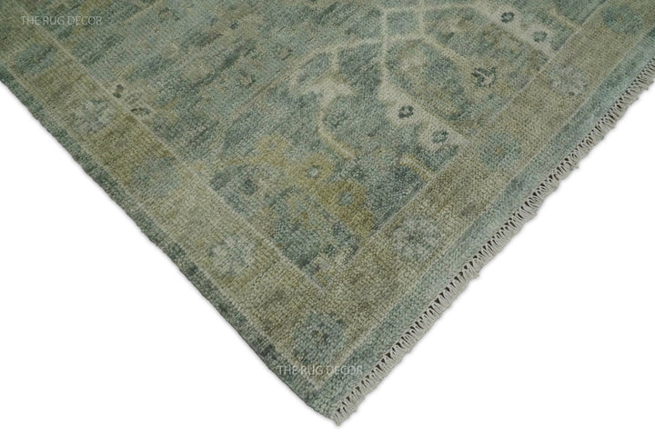 Rug corner showing the blue and ivory pattern, bound edge, and fringe
