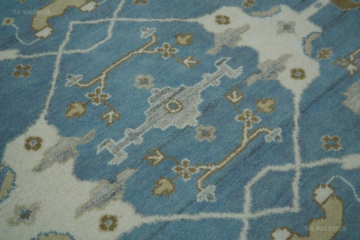 Detail of the rug's blue field with ivory and muted gold floral motifs