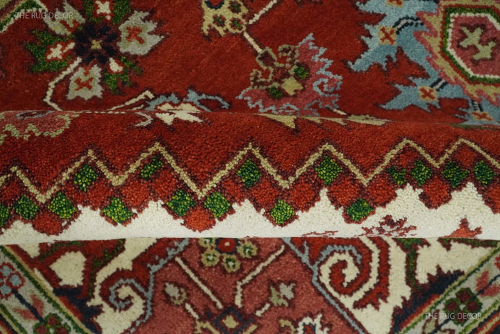 Hand-knotted rug edge detail showing a red patterned pile and geometric border