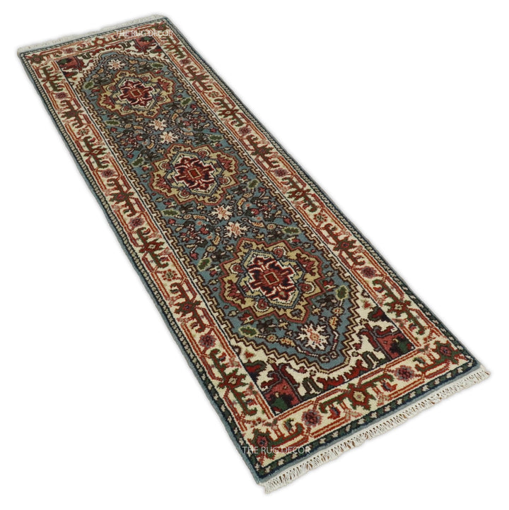 Blue and ivory patterned wool runner rug shown at an angle
