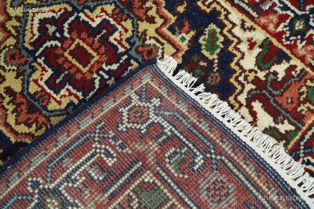 Runner rug close-up showing patterned wool pile, woven backing, and fringe