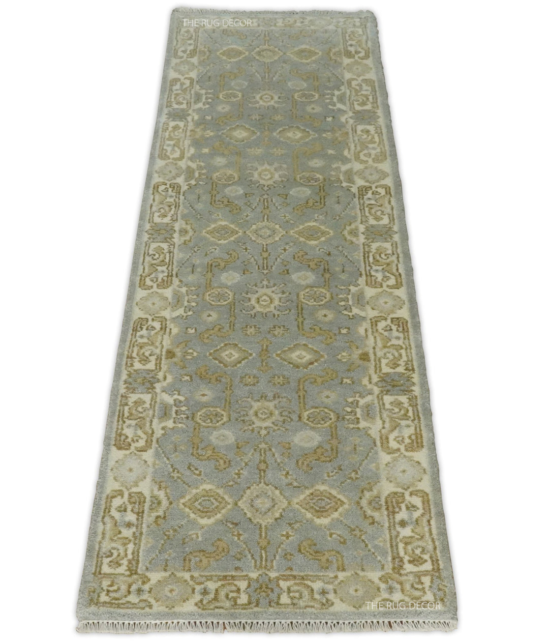 Full view of the gray and beige runner rug with an ornate floral border