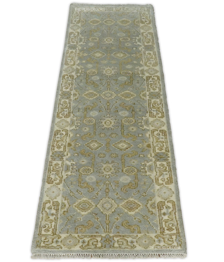 Full view of the gray and beige runner rug with an ornate floral border