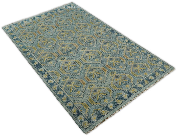 Angled view of the full rug with antique blue and mustard geometric pattern and border
