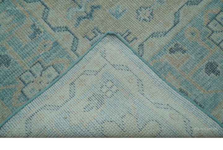 Close-up corner of hand-knotted wool rug with blue and beige geometric border