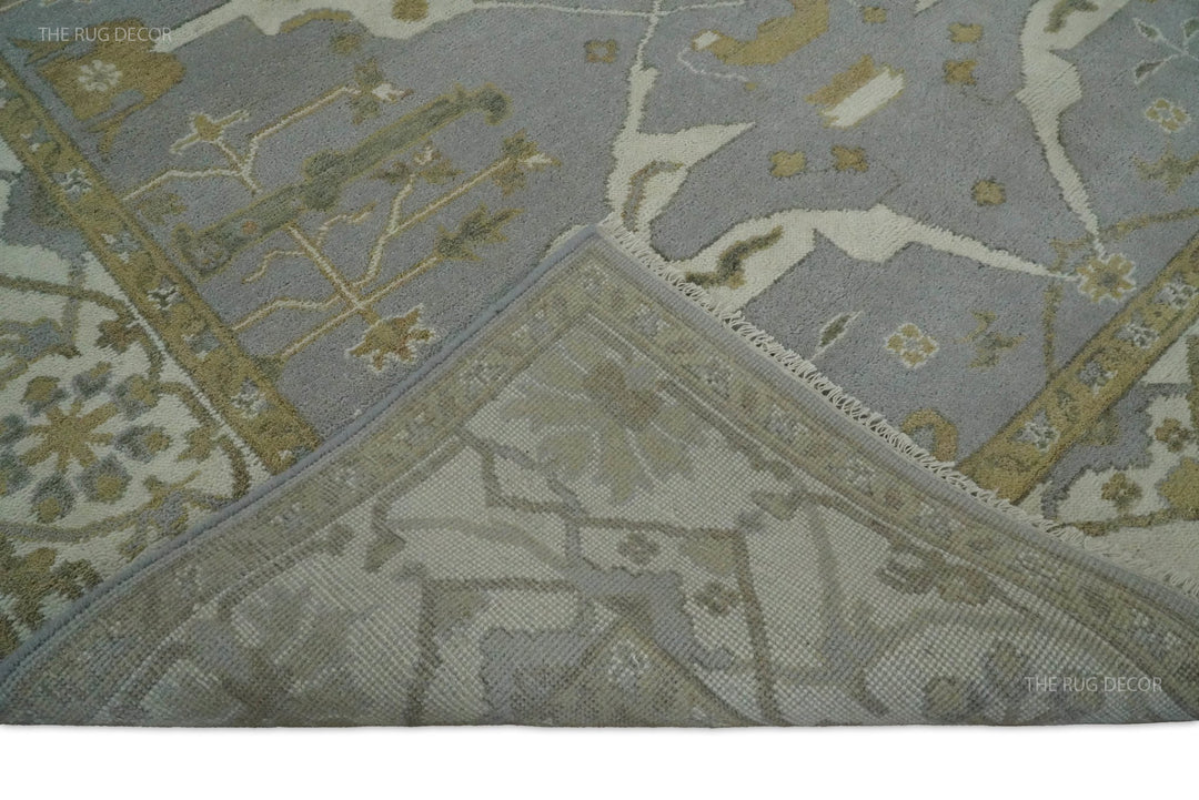Folded corner reveals the woven backing of the gray and ivory wool rug