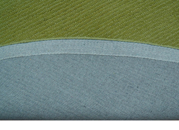 Green wool rug backing with a curved bound edge