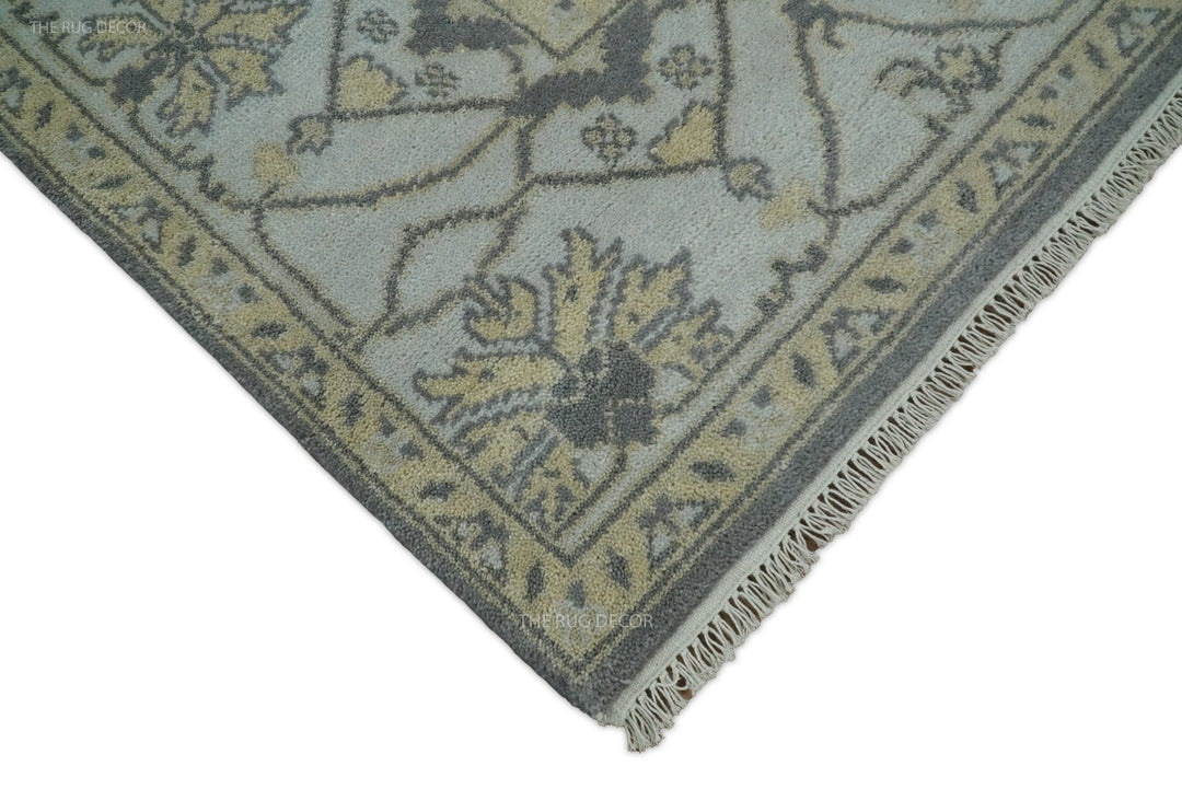 Corner view of vintage Oushak-style wool rug with fringe and gray ivory pattern