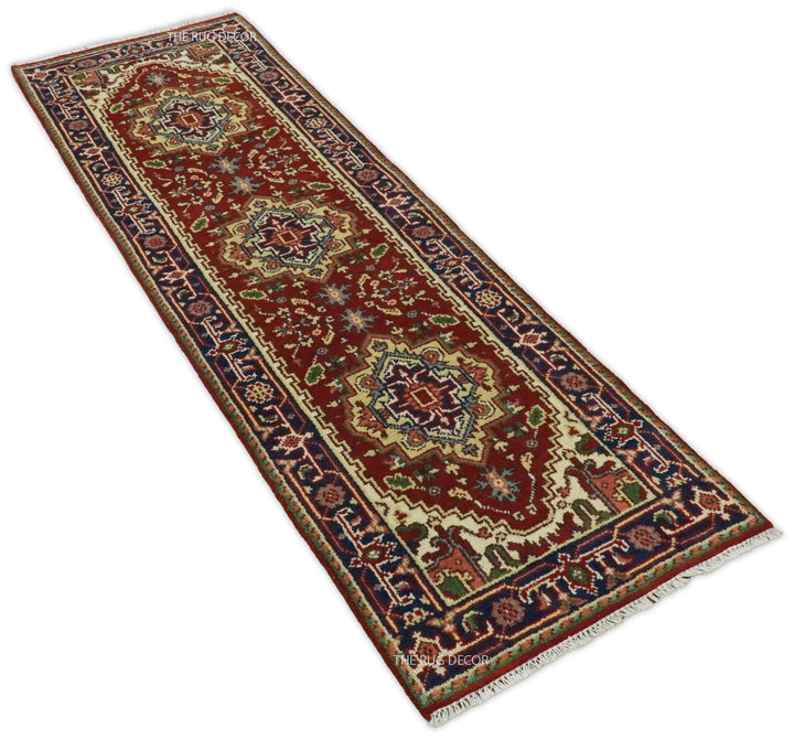 Angled view of the long red runner rug with blue borders and repeated medallions
