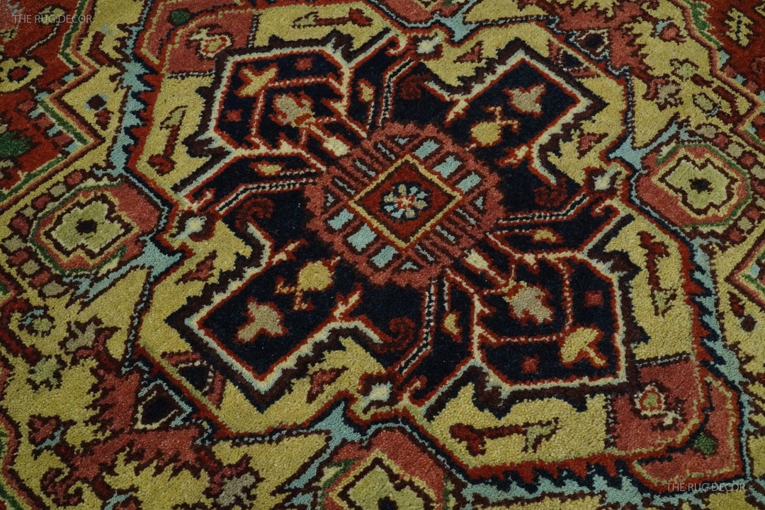 Close-up of central medallion with dark blue and rust red elements on cream ground