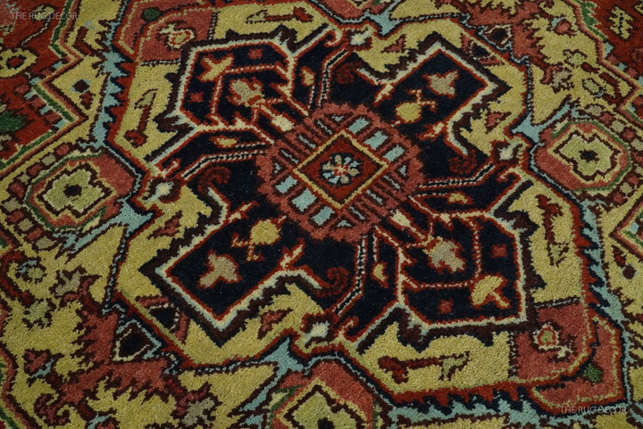 Close-up of central medallion with dark blue and rust red elements on cream ground
