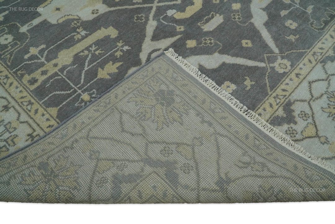 Corner detail on vintage Oushak-style rug showing layered border lines in gray
