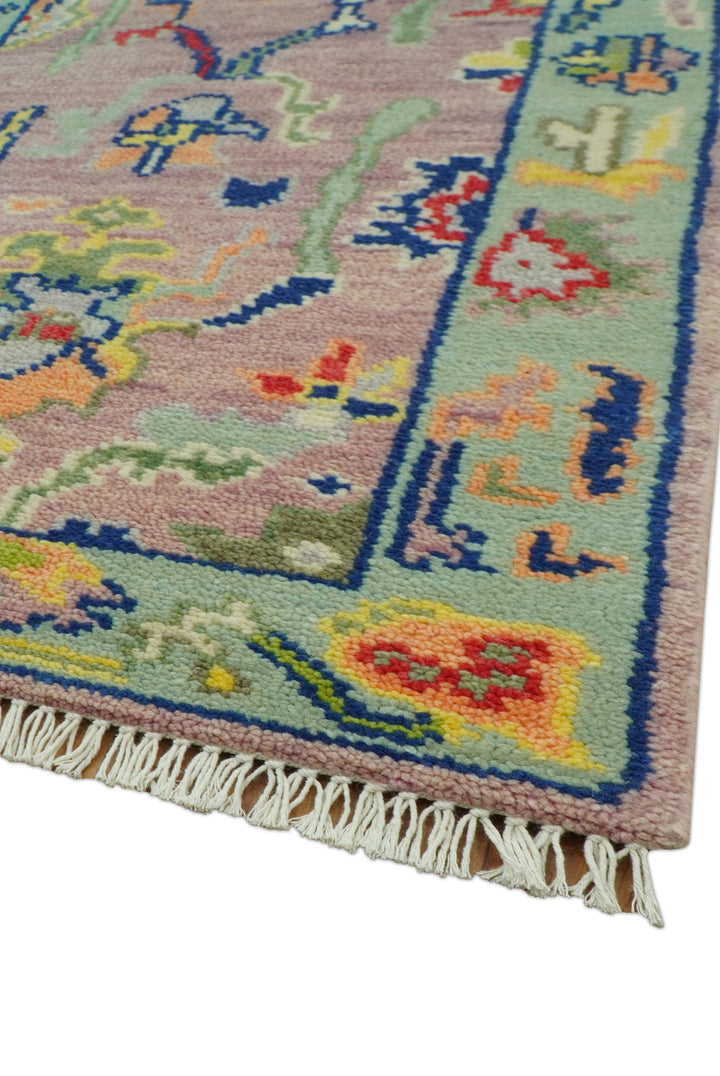 Corner view of Traditional Oushak wool rug with blue border and short cream fringe