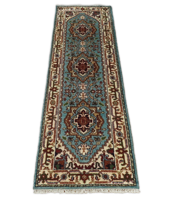 Full view of a traditional blue and ivory runner rug with ornate borders