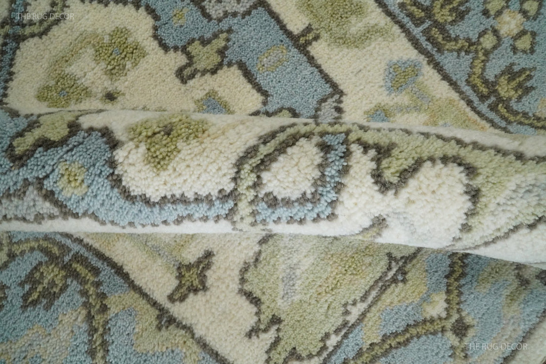 Folded edge reveals the thick pile of the ivory and blue wool runner rug