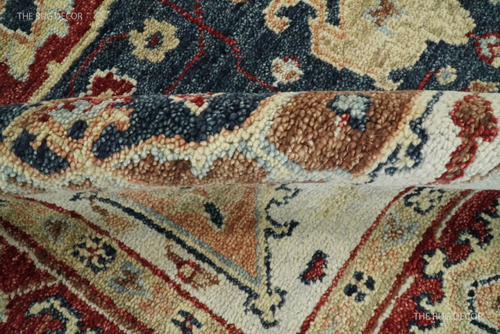 Folded rug edge showing its thick wool pile and woven geometric pattern