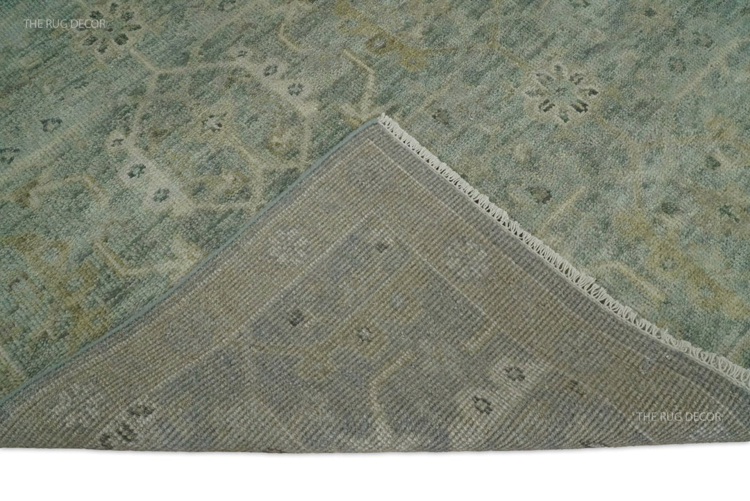 Folded rug corner showing its woven backing and fringed edge