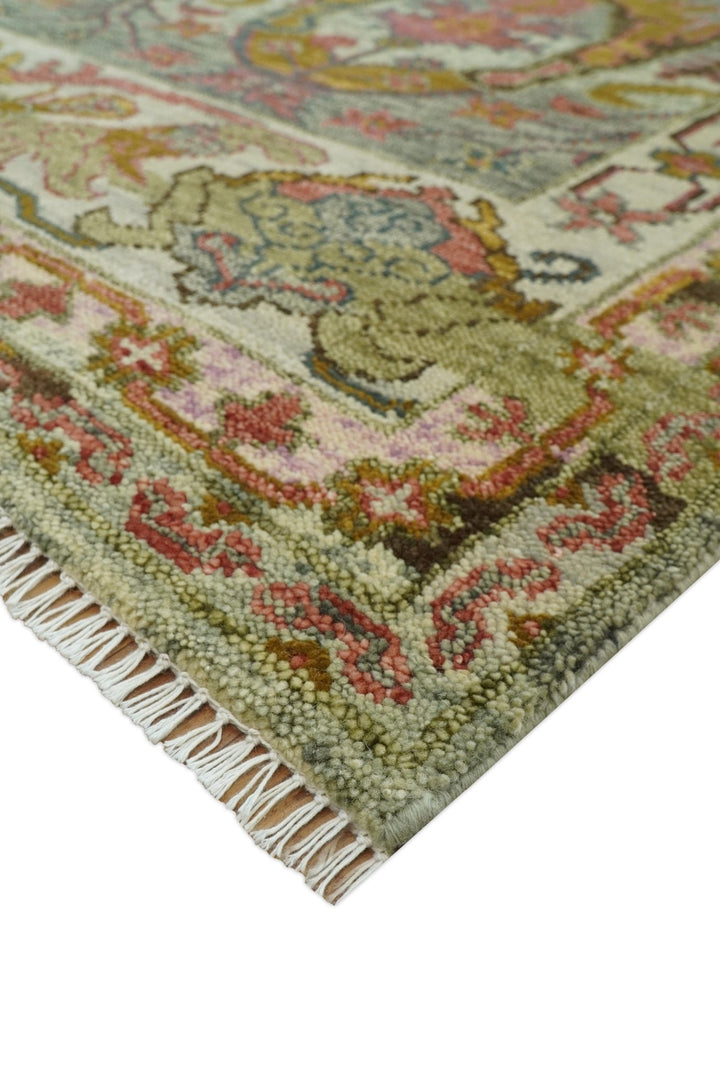 Hand-knotted wool rug corner with cream ground, rust detail, and fringed edge