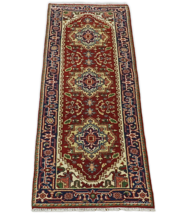 Traditional runner rug with a red center, three medallions, and ornate blue borders