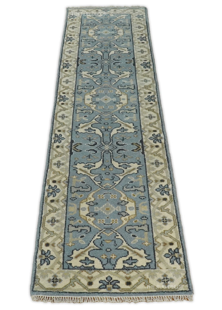 Blue-gray floral runner rug with beige borders, shown lengthwise