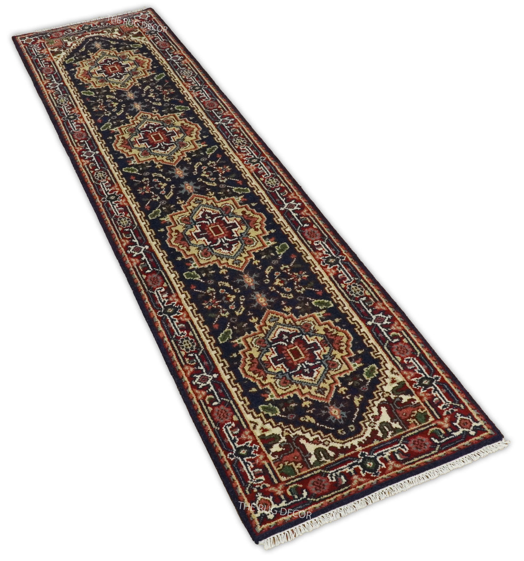 Angled view of a traditional runner rug with red and dark blue geometric medallions