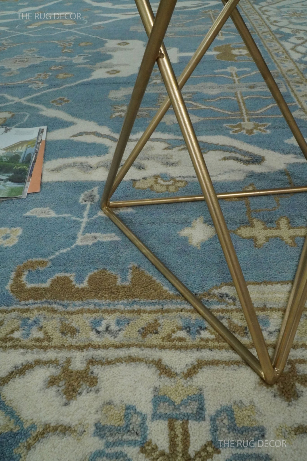 Close-up of the blue wool rug pile and ivory floral border
