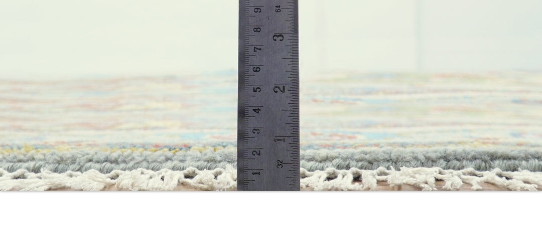 Round multicolor wool rug edge with short fringe and visible pile height measurement