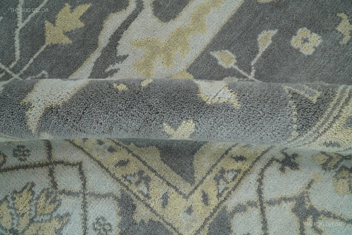 Close-up section of vintage Oushak-style wool rug with gray and ivory motifs