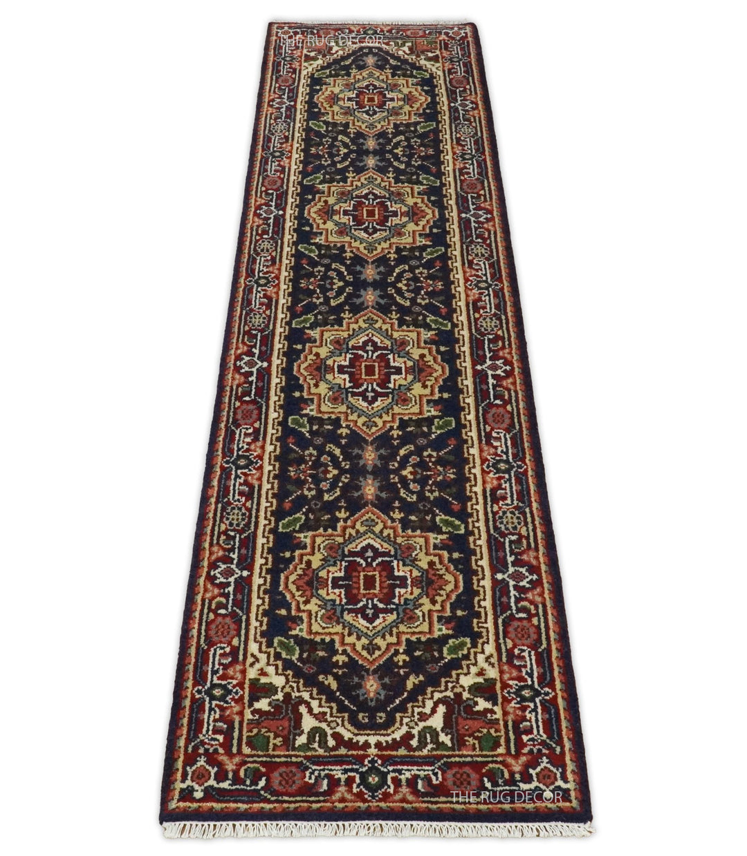Full-length wool runner rug with red borders, dark blue field, and geometric medallions