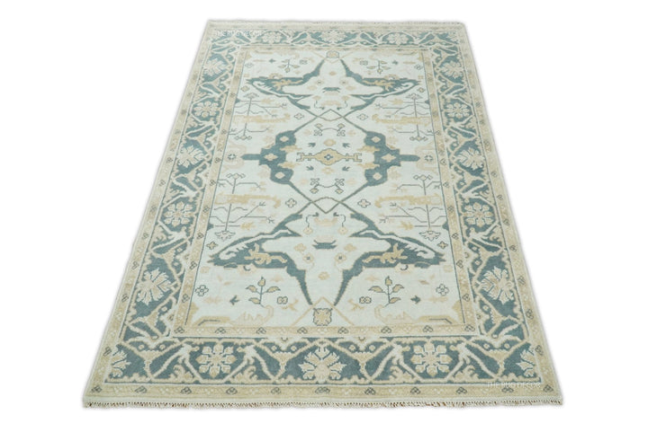 Teal and ivory Oushak wool rug with central medallion and floral vine border