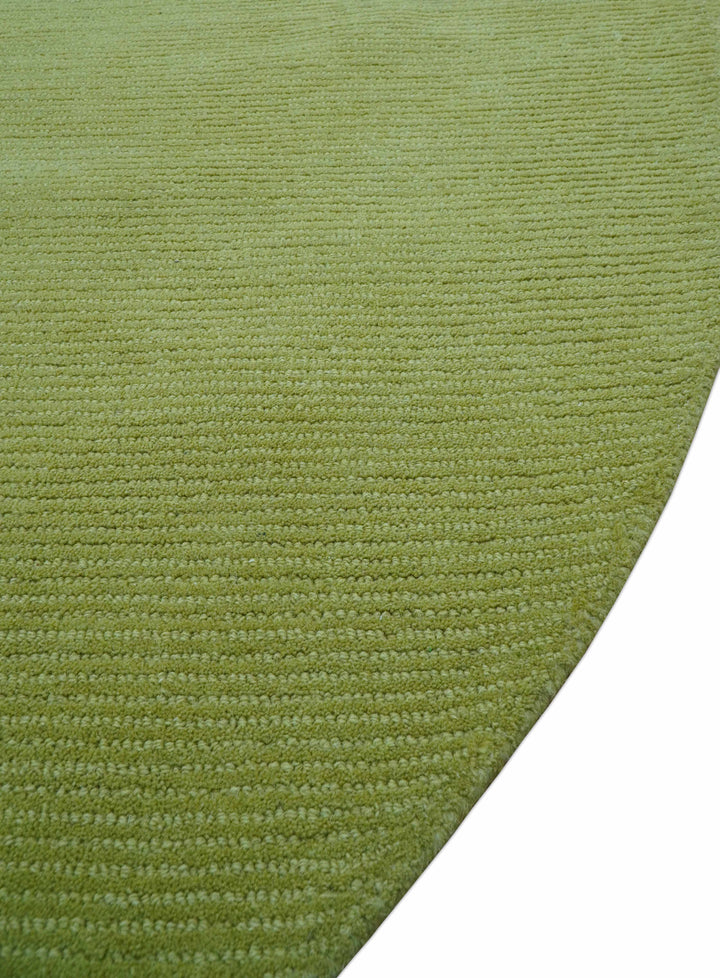 Close-up of the rug's green textured surface and curved edge