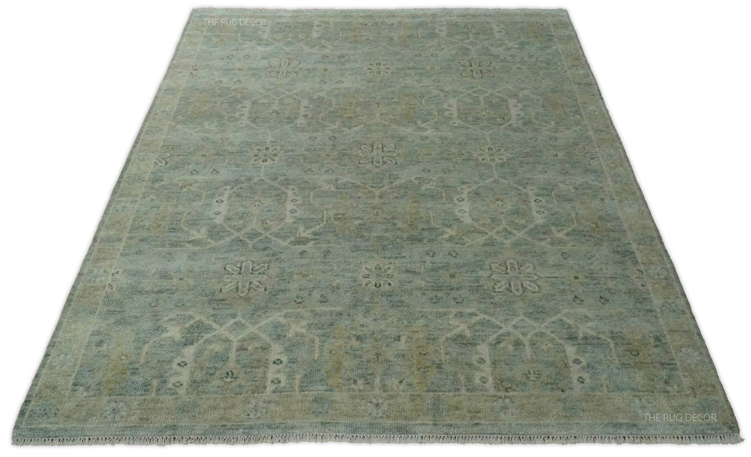 Traditional blue and ivory wool rug with floral motifs and a decorative border
