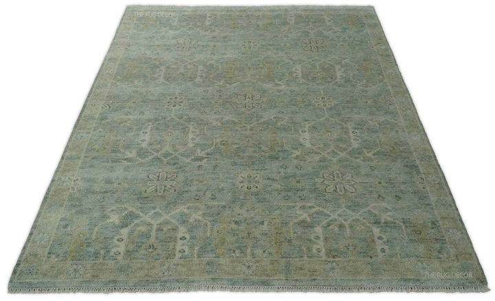Traditional blue and ivory wool rug with floral motifs and a decorative border