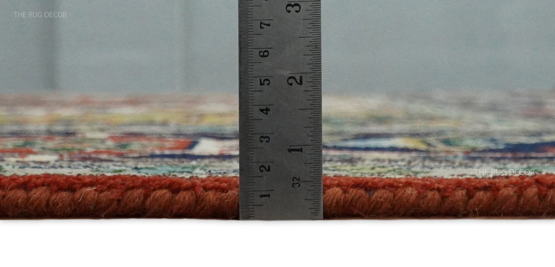 Rust and blue traditional Heriz Serapi area rug with fringed border, measured edge view