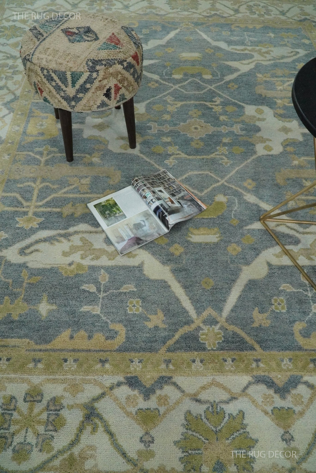 Gray and beige Oushak rug with a floral medallion and wide border