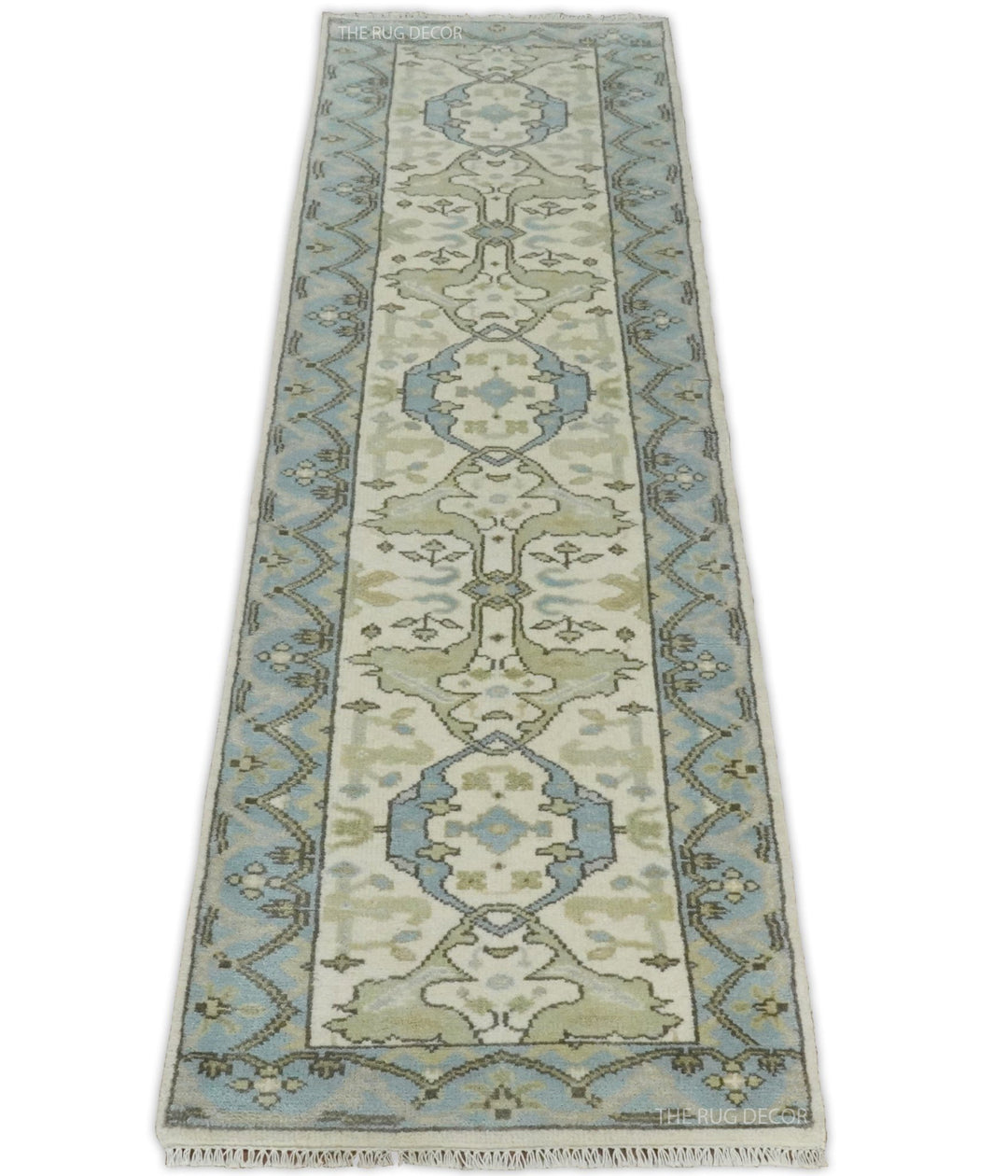 Ivory and blue wool runner rug with a central floral design and geometric side borders
