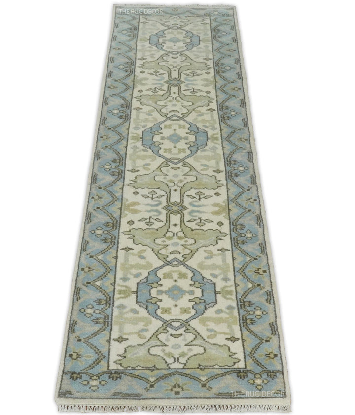 Ivory and blue wool runner rug with a central floral design and geometric side borders