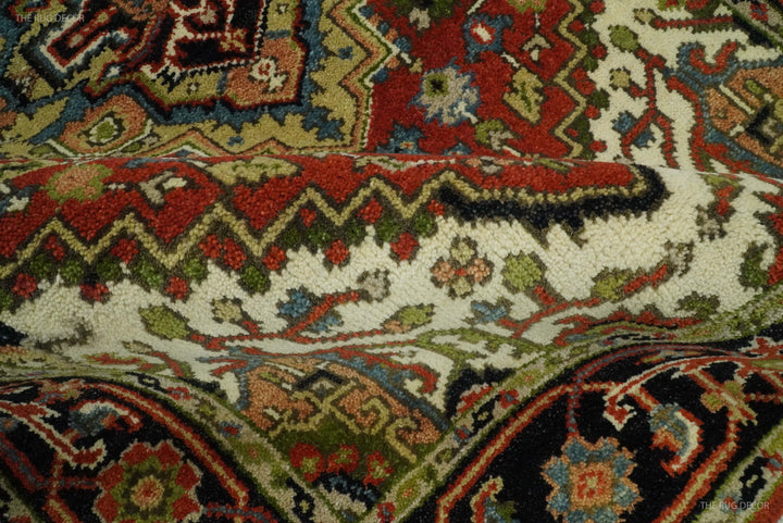 Close-up of Serapi rug with red, green and navy accents on cream ground