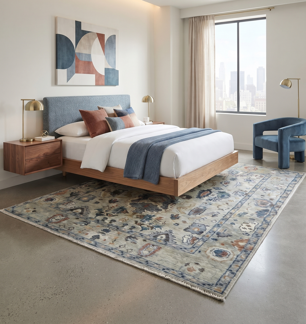 Traditional beige and blue wool rug displayed beneath a bed, with a central medallion pattern