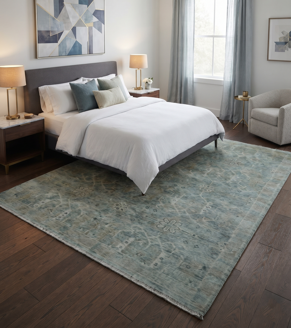 Traditional blue and ivory wool rug displayed beneath a bed