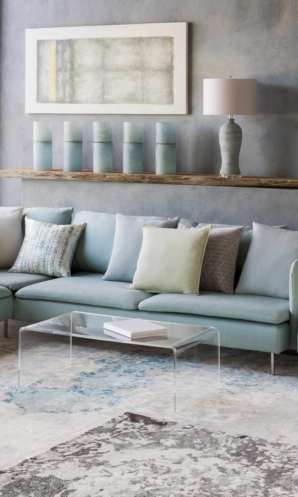 Beige and light blue abstract area rug displayed under living room furniture