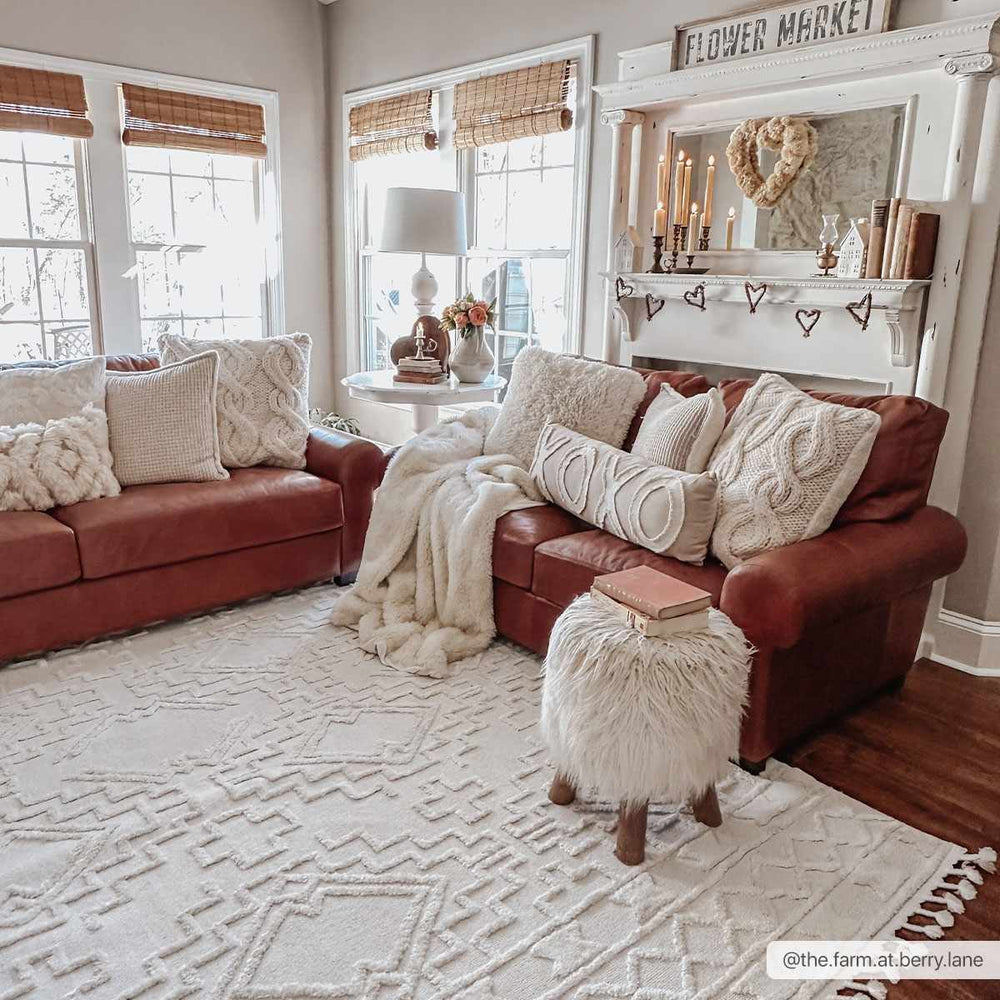 Ivory geometric area rug with repeating maze motif and short fringe edge