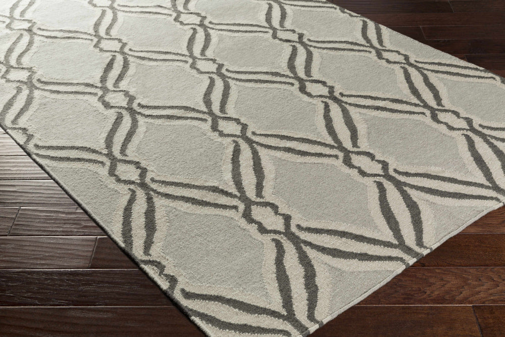 Gray geometric hand-woven wool area rug with trellis pattern, angled corner view
