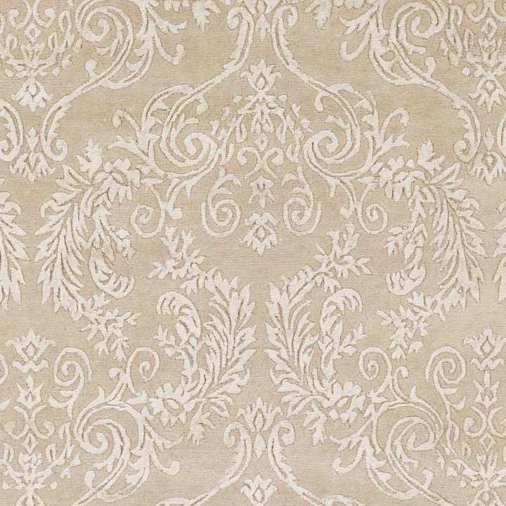 Beige traditional rug close-up with detailed scrolling vines and floral design
