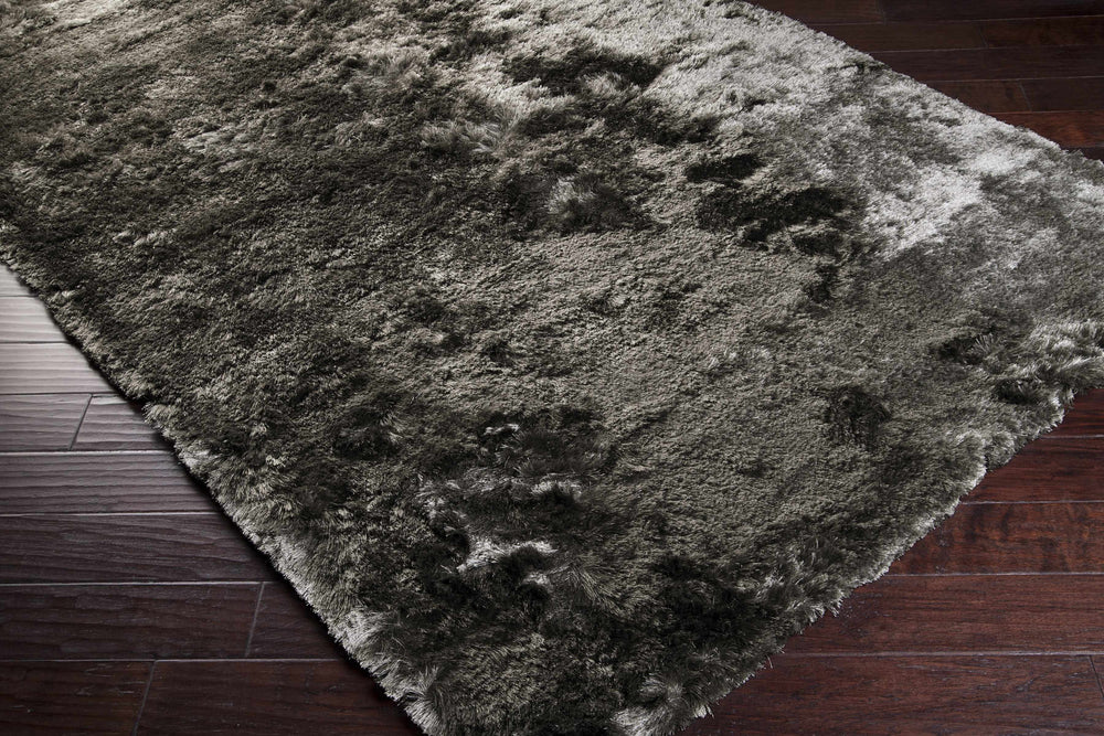 Charcoal hand-woven area rug with plush shag pile, corner view