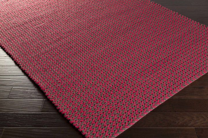 Red hand-woven area rug, rectangular, visible edge and textured weave detail