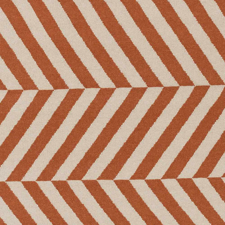 Close-up of orange and cream chevron stripe area rug pattern