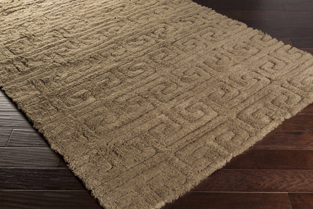 Camel hand-woven wool area rug with repeating geometric motif, corner angle view.